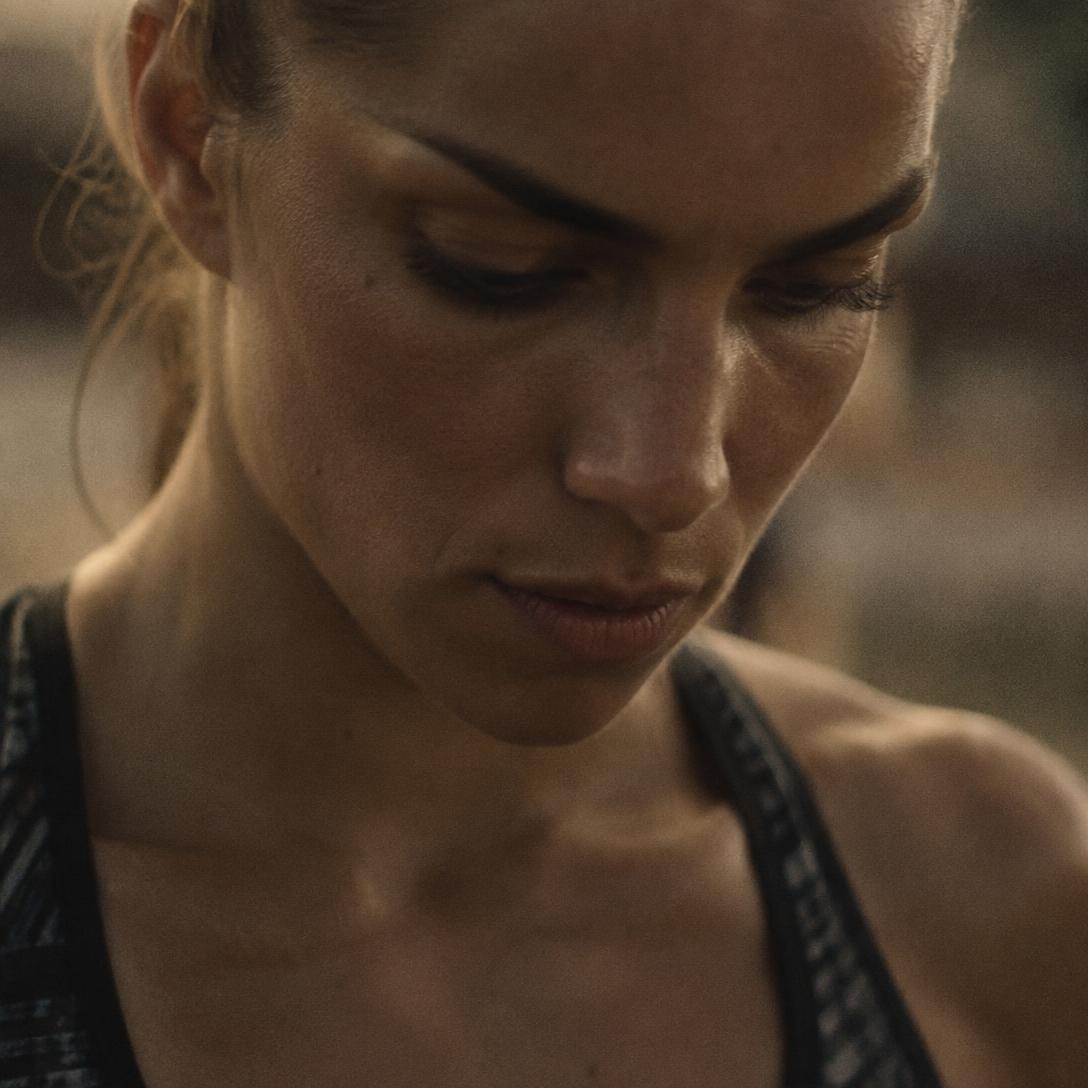 Close-up of an athlete in warm light, focused before a race