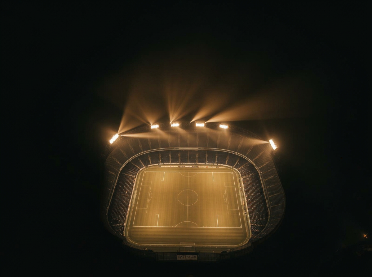 Floodlit stadium seen from above at night